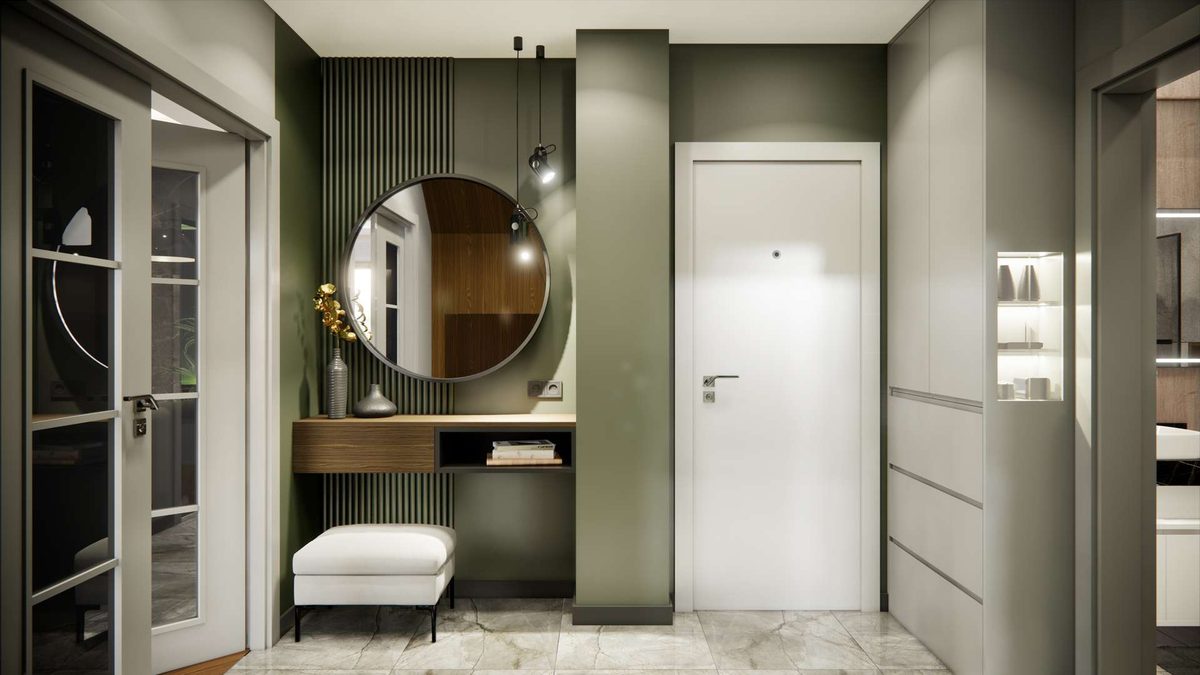 Entrance hall: round mirror, olive-green wall and a low ottoman