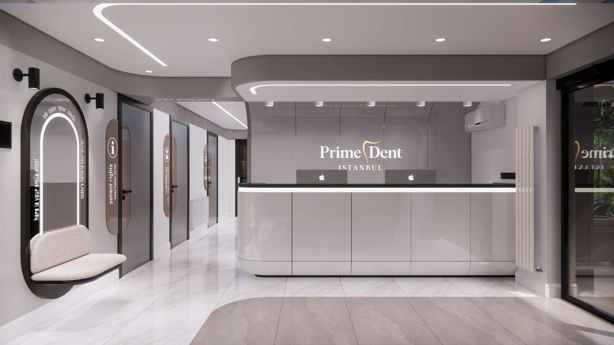 Reception desk with the illuminated PrimeDent sign behind it